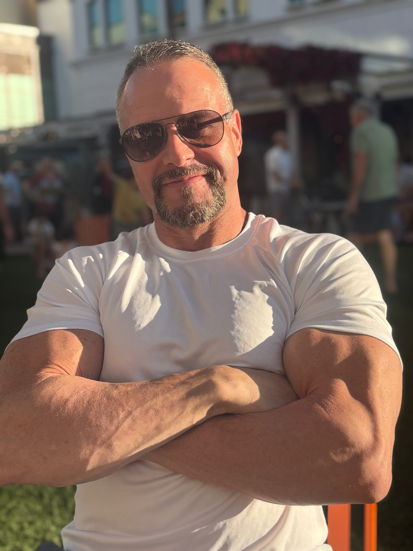 James Villepigue, CSCS, arms crossed in a white t-shirt